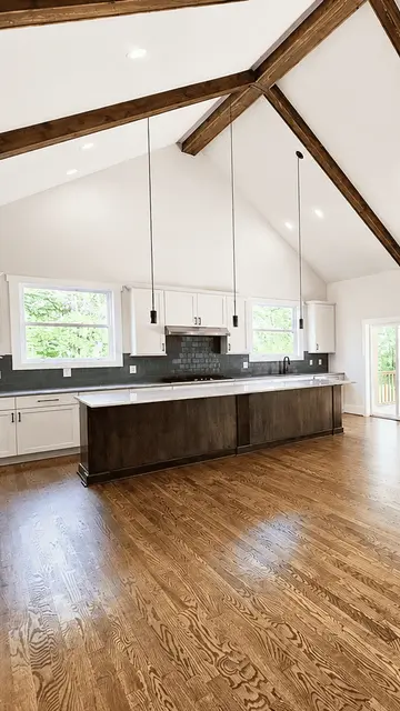 A vaulted kitchen with a long island in a Travars home